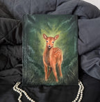 Oil Painting of a deer on a dark fabric background with pearls around it