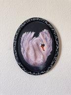oil painting of a swan with an ornamental border on a white wall