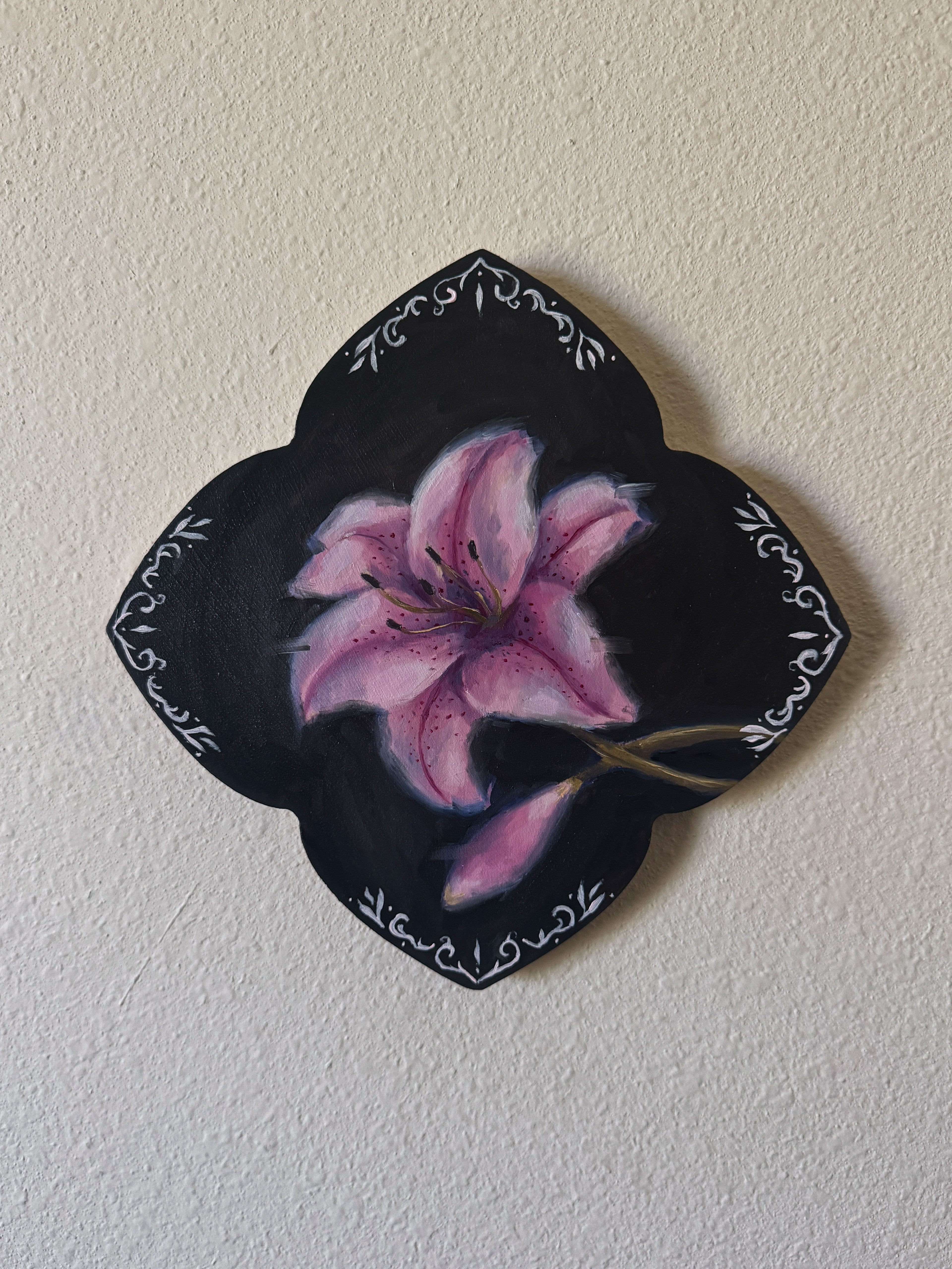 Oil Painting of a pink lily flower with an ornamental border on a white wall