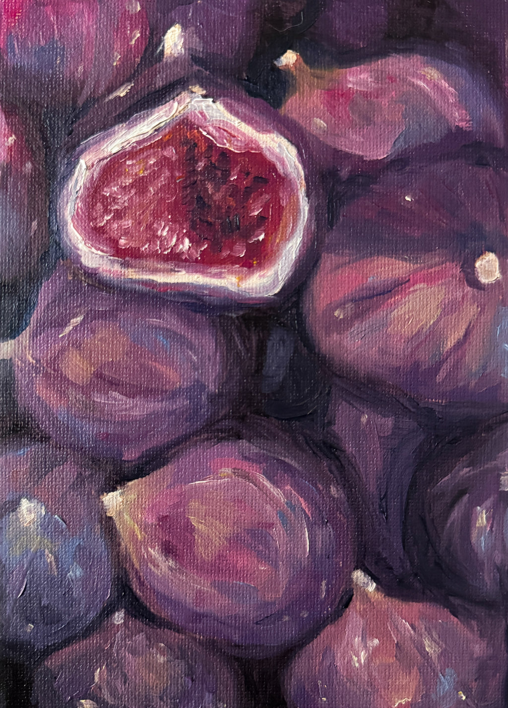 Oil painting of figs with a focus on one cut open fig.