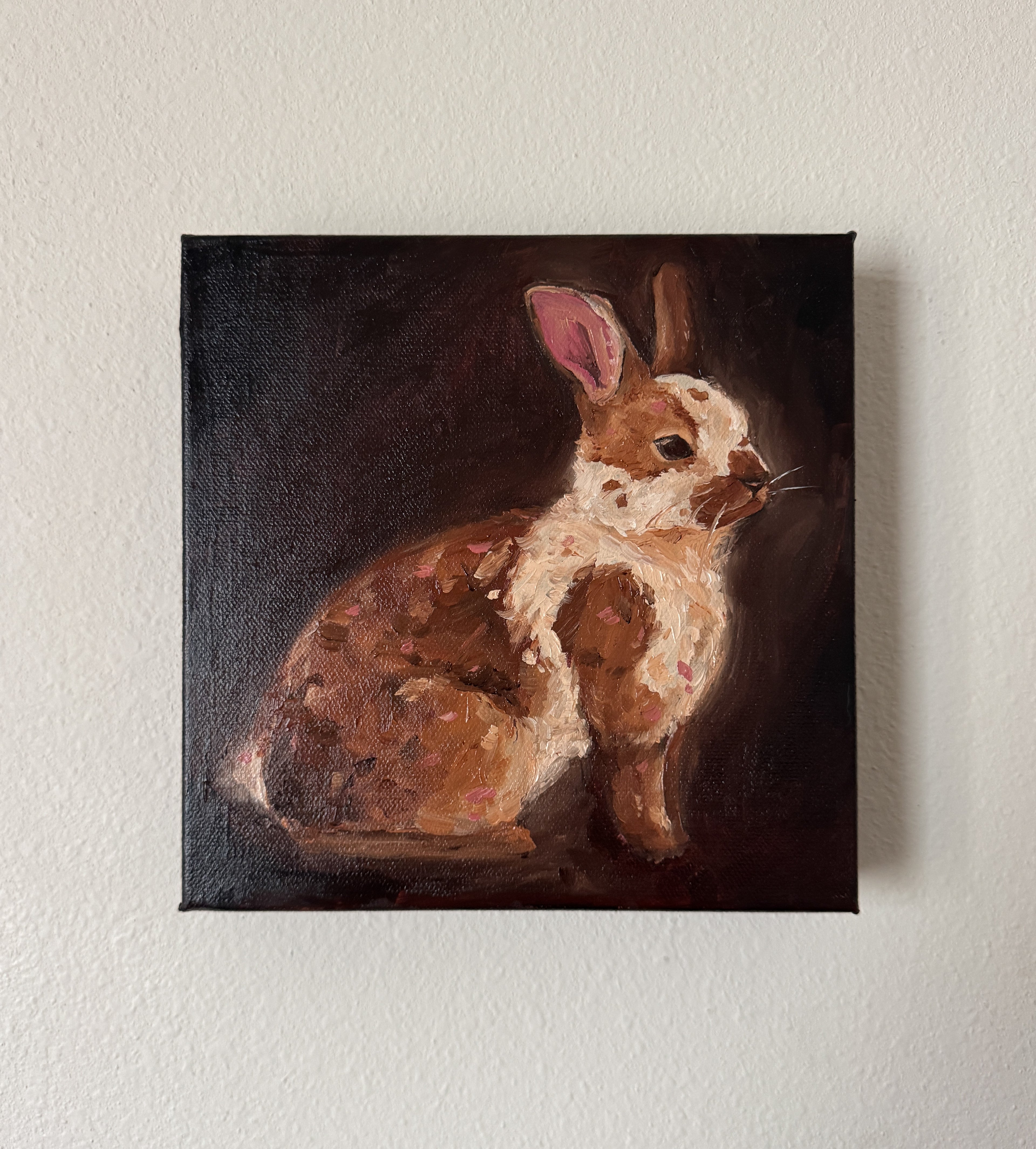 Canvas painting of a rabbit on a white wall