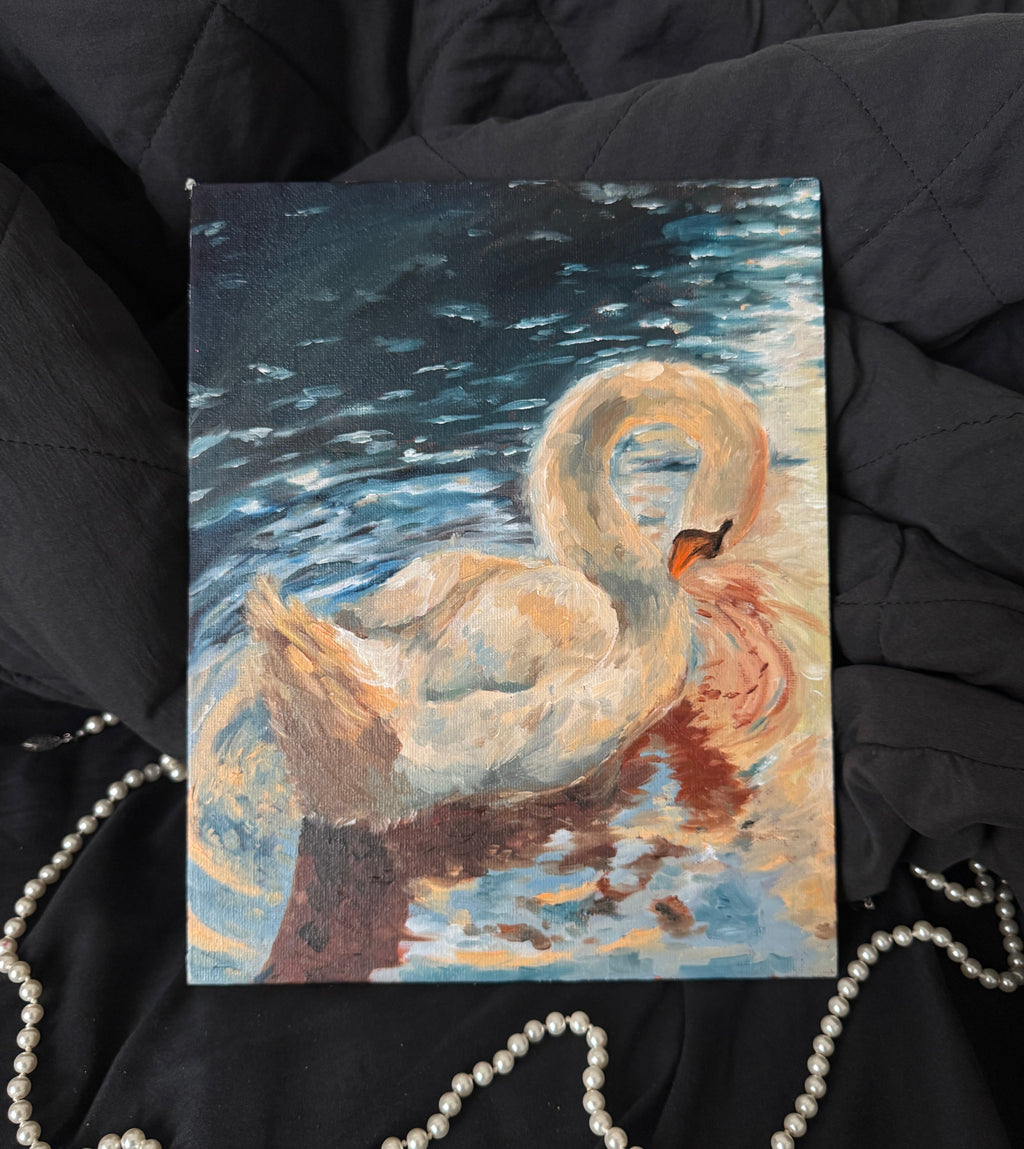 Painting of a swan on a dark fabric background with a pearl necklace.