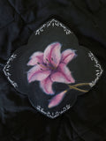 Oil painting of a lily flower with ornamental border on a dark background