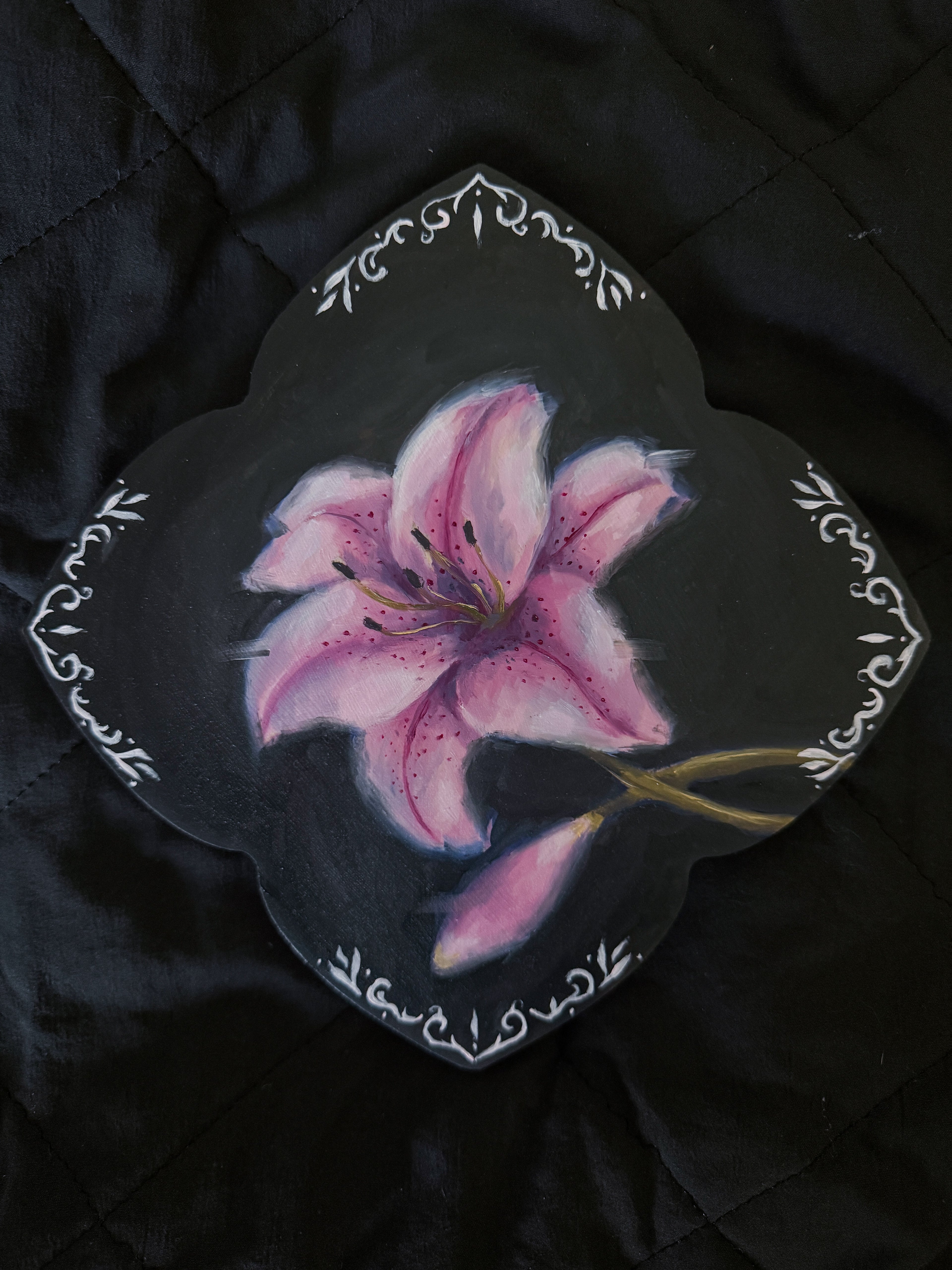 Oil painting of a lily flower with ornamental border on a dark background